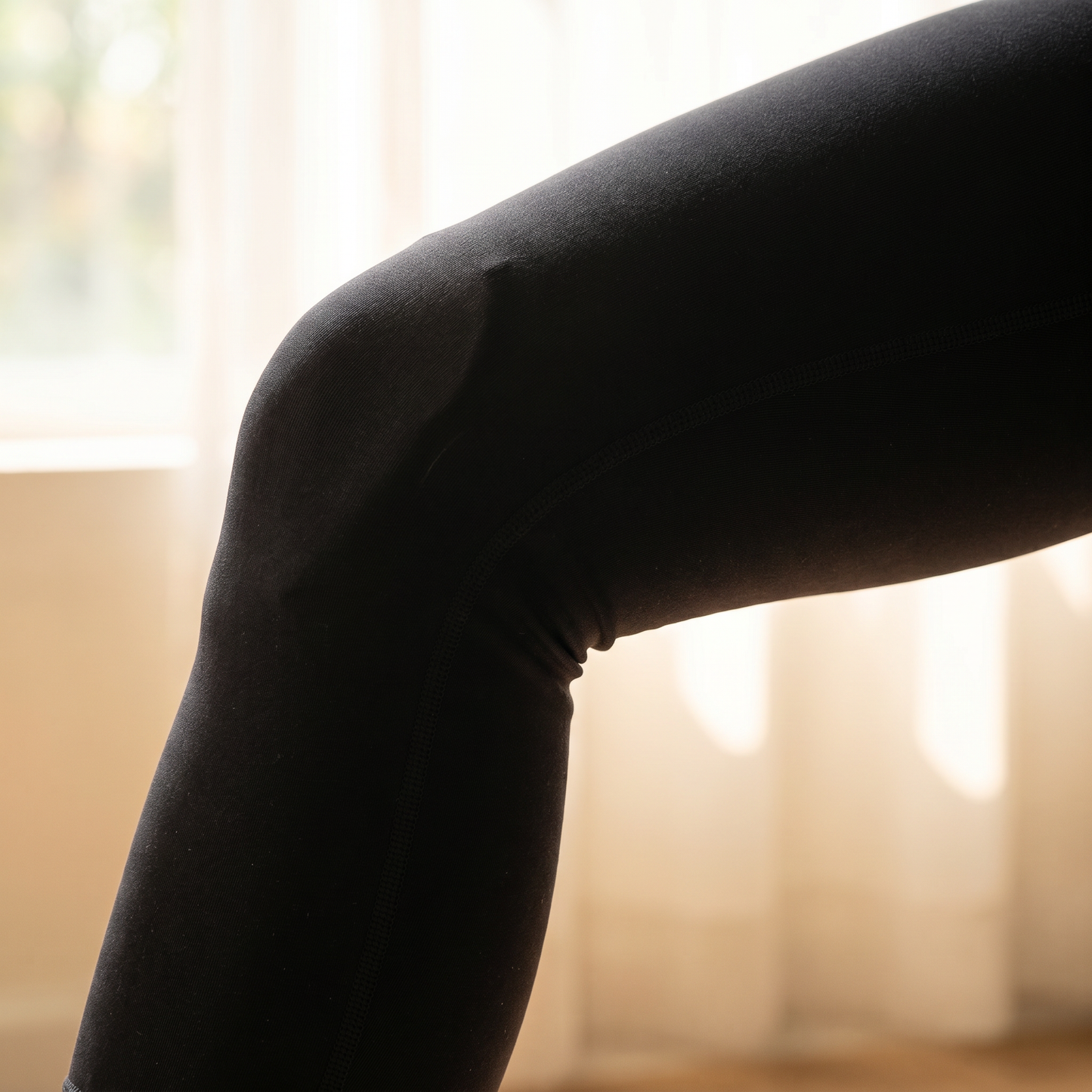 KINEO Pro showing low-profile fit worn discreetly under black athleisure leggings