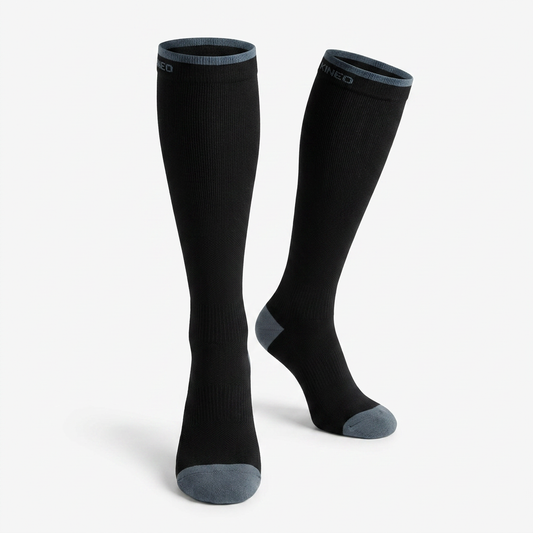 KINEO Compression Socks — knee-high pair, grey contrast cuff + heel + toe. Studio hero shot.